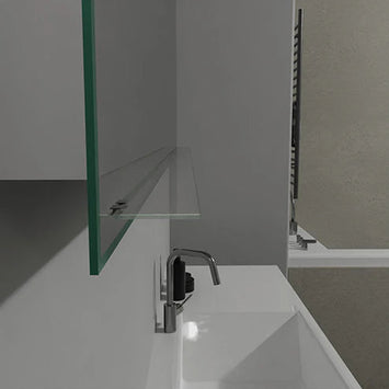 Glasablage unter einem modernen Badezimmerspiegel über einem weißen Waschbecken.